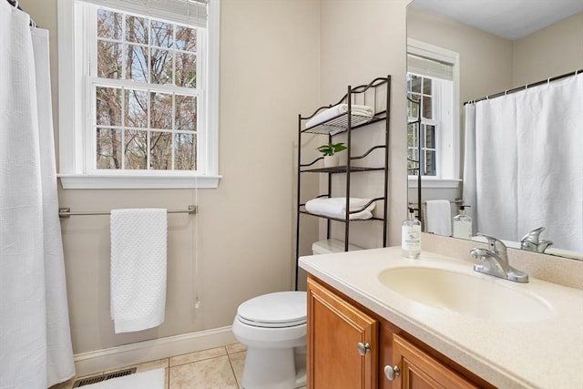 bathroom with plenty of natural light, baseboards, and tile patterned flooring