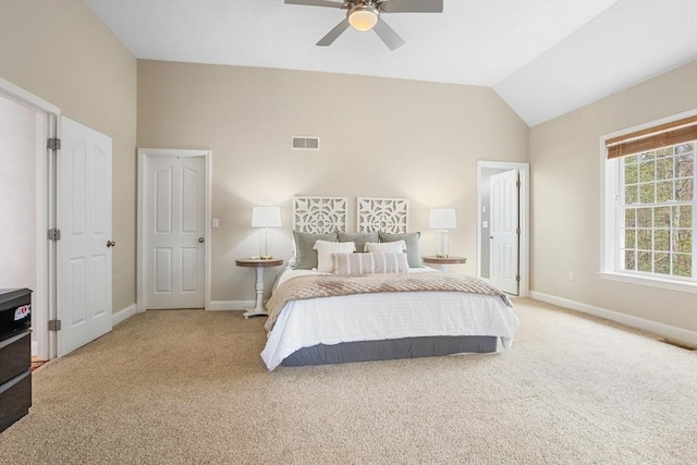 bedroom featuring visible vents, baseboards, ceiling fan, light colored carpet, and vaulted ceiling