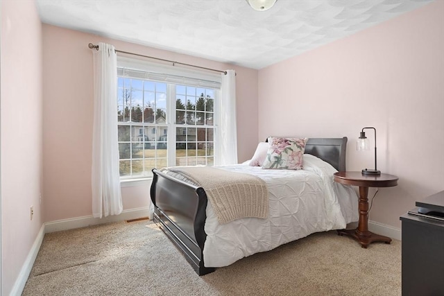 bedroom with baseboards and carpet flooring