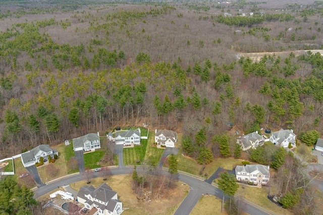 drone / aerial view featuring a view of trees and a residential view