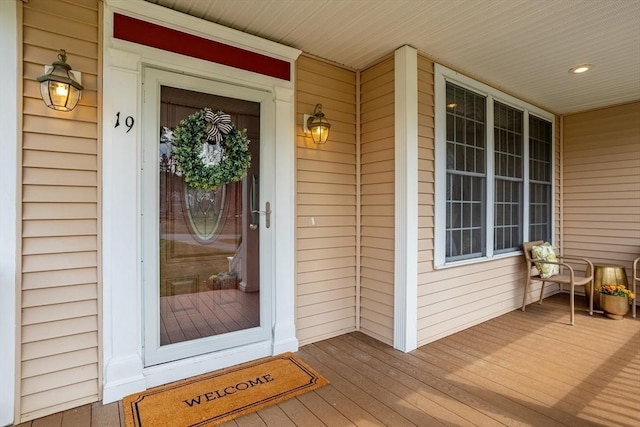 view of exterior entry featuring covered porch