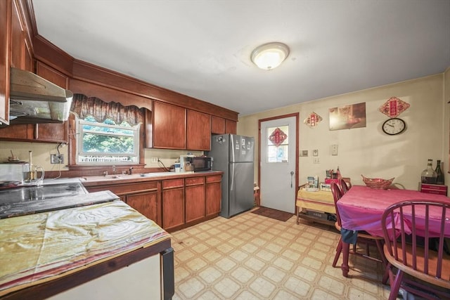 161 Columba St, Chicopee, MA 01020 - kitchen featuring freestanding refrigerator, premium range hood, light floors, and light countertops