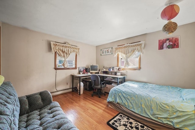161 Columba St, Chicopee, MA 01020 - bedroom featuring multiple windows, light wood-style floors, an office area, and baseboard heating