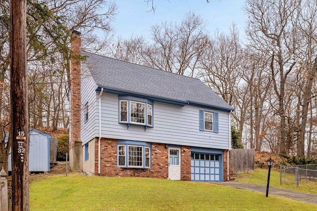 view of front of property with a garage, a shed, and a front lawn