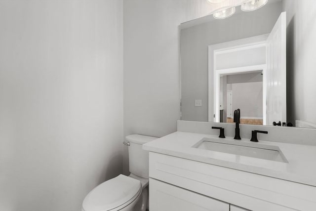 bathroom featuring toilet and vanity