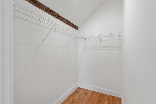 spacious closet with lofted ceiling and hardwood / wood-style floors