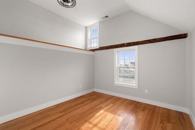 empty room featuring high vaulted ceiling and wood-type flooring