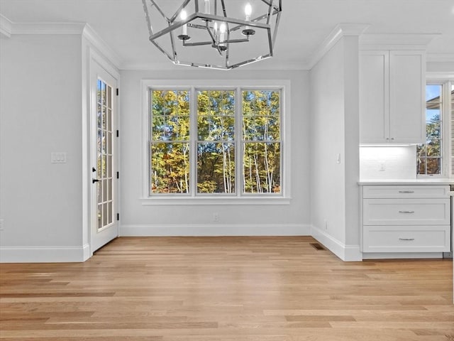 35 Lincoln St, Hopkinton, MA 01748 - unfurnished dining area featuring a chandelier, crown molding, and light wood finished floors