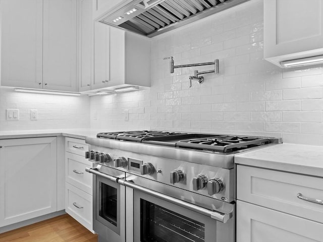 35 Lincoln St, Hopkinton, MA 01748 - kitchen with double oven range, custom exhaust hood, backsplash, white cabinetry, and light stone countertops