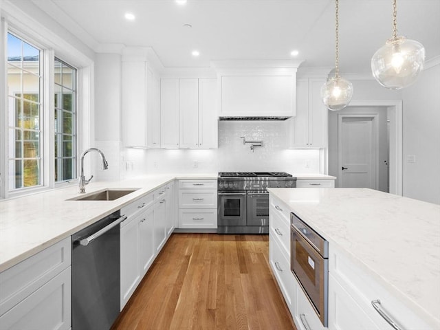 35 Lincoln St, Hopkinton, MA 01748 - kitchen featuring appliances with stainless steel finishes, light wood-type flooring, decorative backsplash, recessed lighting, and light stone countertops