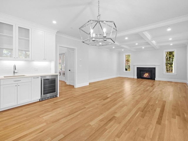 35 Lincoln St, Hopkinton, MA 01748 - unfurnished living room featuring wine cooler, recessed lighting, bar with sink, a chandelier, and light wood finished floors