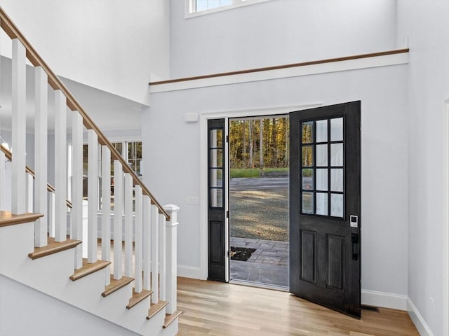 35 Lincoln St, Hopkinton, MA 01748 - entryway featuring a towering ceiling, wood finished floors, and stairs