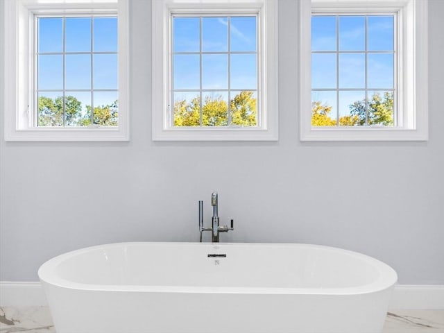 35 Lincoln St, Hopkinton, MA 01748 - bathroom featuring marble finish flooring, a freestanding bath, and plenty of natural light