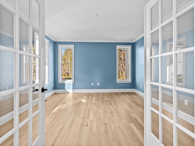 35 Lincoln St, Hopkinton, MA 01748 - spare room featuring french doors, ornamental molding, and light wood-style flooring