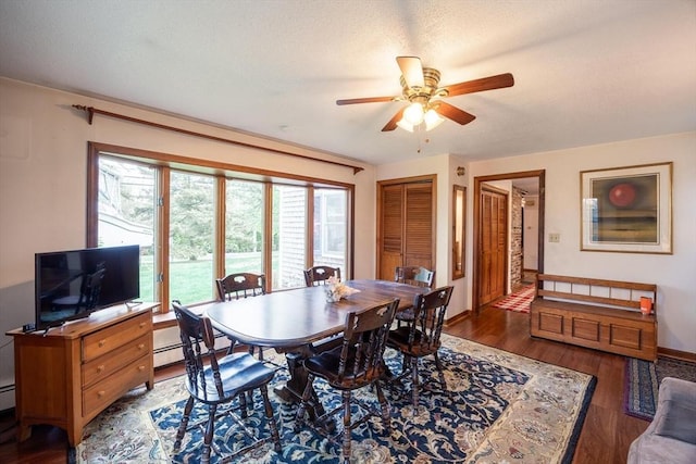 dining area featuring a ceiling fan, wood finished floors, and baseboards