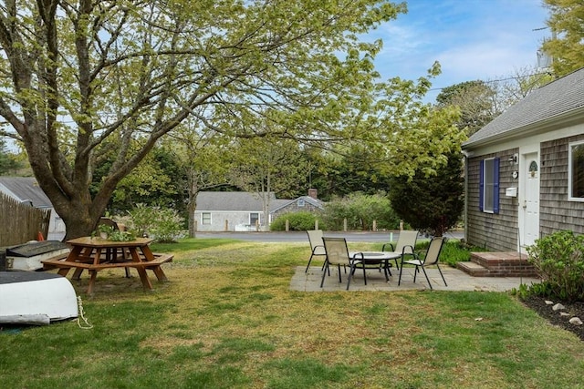 view of green lawn featuring a patio area