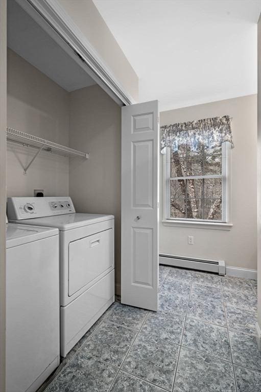 clothes washing area featuring baseboards, laundry area, washer and dryer, tile patterned floors, and a baseboard heating unit