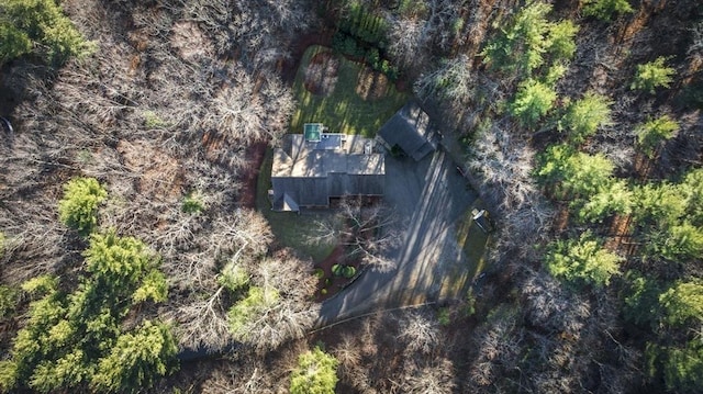 bird's eye view with a wooded view