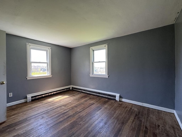 unfurnished room featuring healthy amount of natural light, hardwood / wood-style flooring, and baseboards