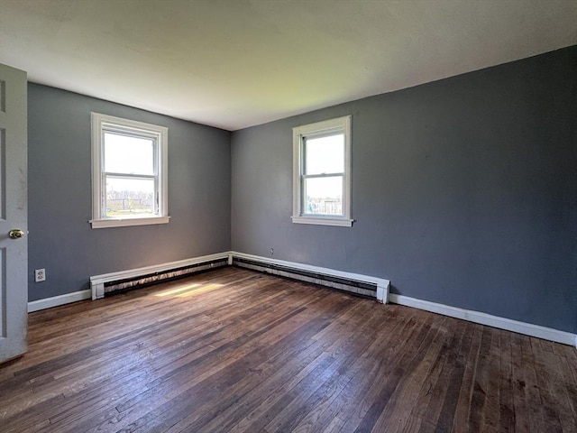 unfurnished room with a baseboard radiator, plenty of natural light, and hardwood / wood-style floors