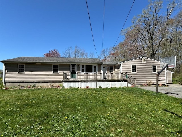 view of front facade featuring a front lawn and a deck