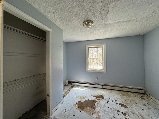 unfurnished bedroom featuring baseboard heating and a textured ceiling