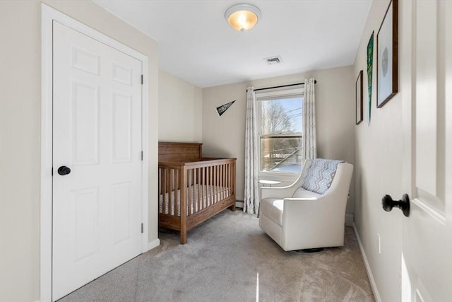 carpeted bedroom with a nursery area and baseboard heating