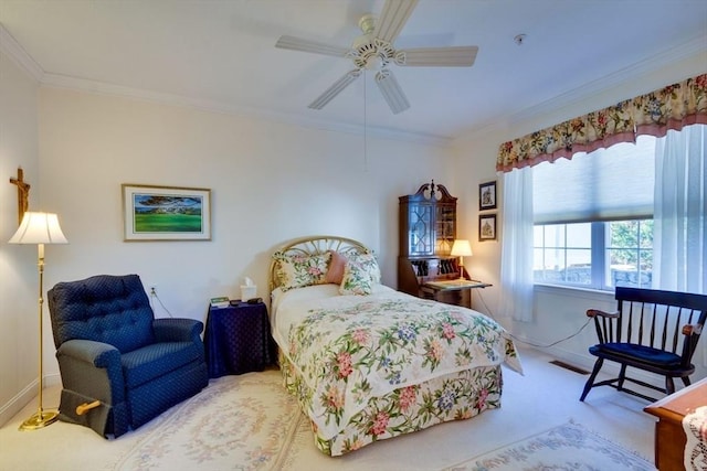 carpeted bedroom featuring visible vents, baseboards, ceiling fan, and ornamental molding