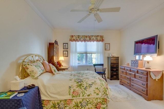 bedroom featuring light colored carpet, ornamental molding, and a ceiling fan