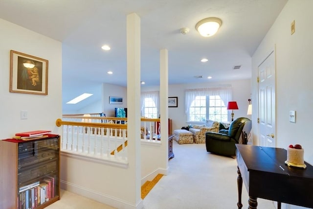 interior space with baseboards, visible vents, carpet floors, recessed lighting, and an upstairs landing