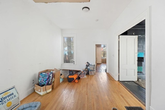 interior space featuring visible vents, baseboards, and wood finished floors