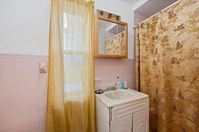 full bath featuring vanity and tile walls