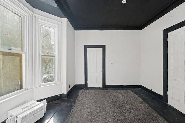 empty room with plenty of natural light, baseboards, and crown molding