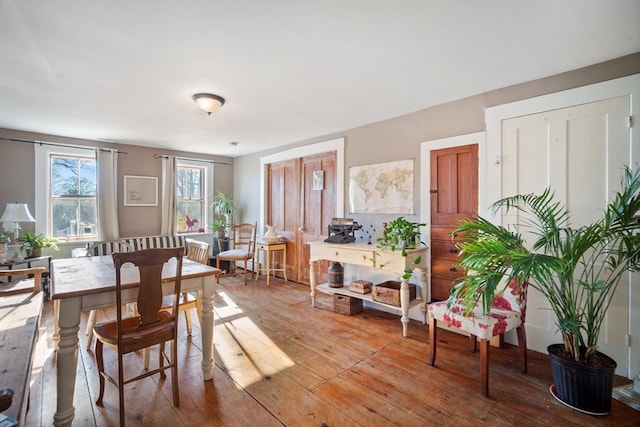 dining space with hardwood / wood-style flooring