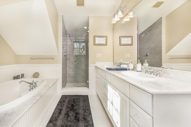 bathroom with tile patterned flooring, vanity, vaulted ceiling, and independent shower and bath