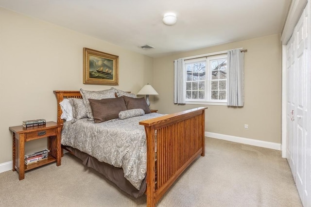 bedroom featuring light colored carpet and a closet