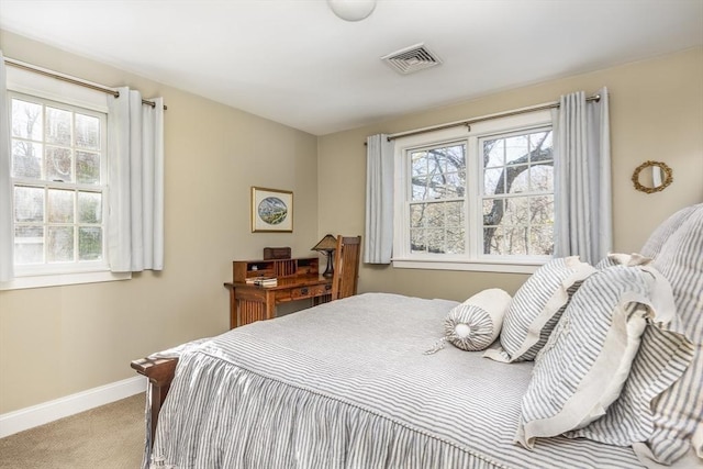 carpeted bedroom featuring multiple windows