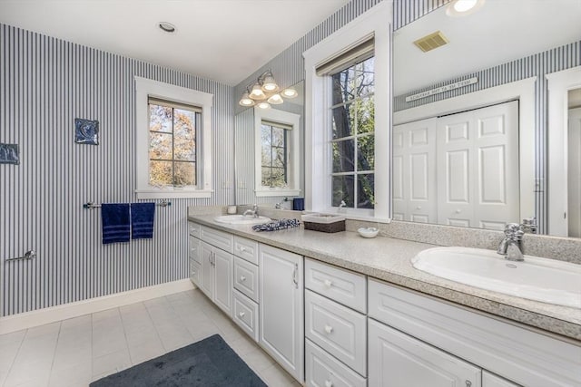 bathroom featuring tile patterned flooring and vanity