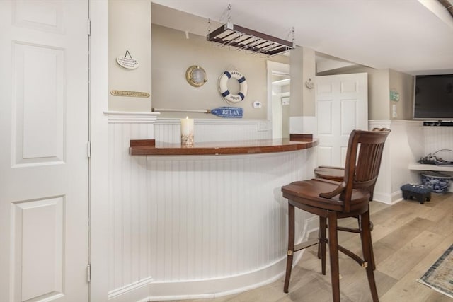 bar featuring light hardwood / wood-style floors