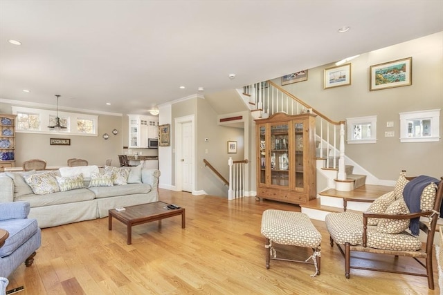 living room featuring light hardwood / wood-style flooring and ornamental molding