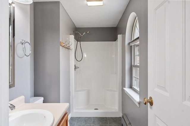 full bathroom featuring walk in shower, tile patterned flooring, and vanity