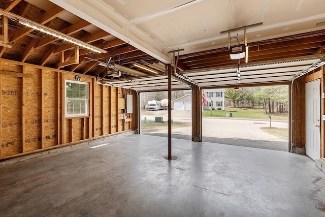 garage featuring a garage door opener and electric panel