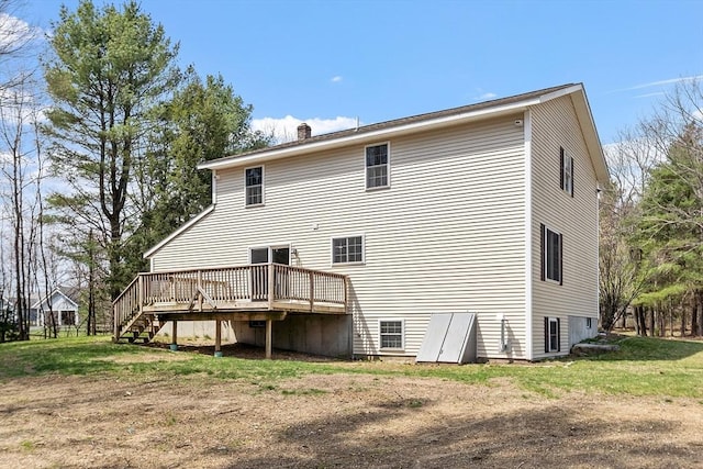 rear view of house featuring a wooden deck, stairway, and a chimney