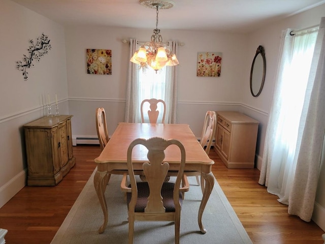 30 Ridgewood Ln, Quincy, MA 02169 - dining area featuring a chandelier, a baseboard heating unit, light wood-type flooring, and a baseboard radiator