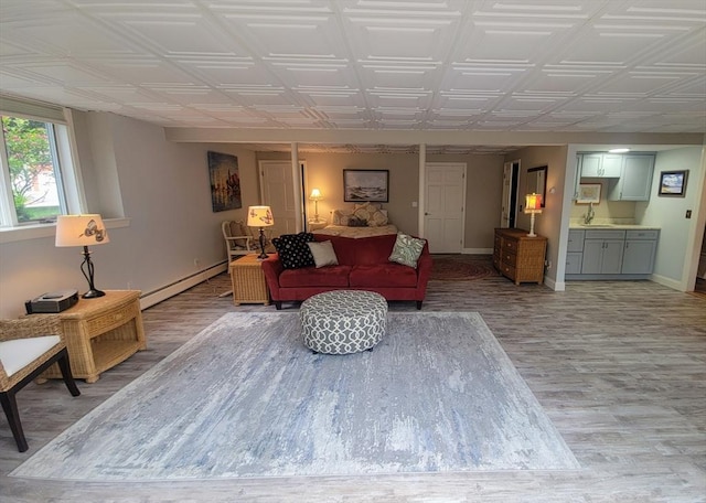 30 Ridgewood Ln, Quincy, MA 02169 - living room with a baseboard radiator, light wood finished floors, and an ornate ceiling
