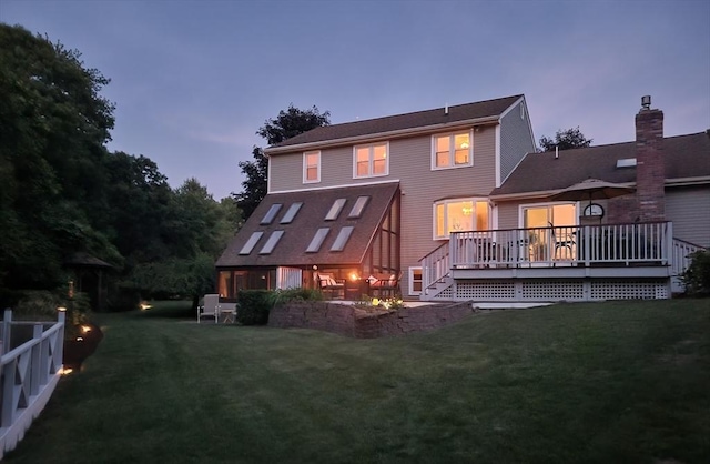 30 Ridgewood Ln, Quincy, MA 02169 - back of property with a lawn, a deck, and a chimney