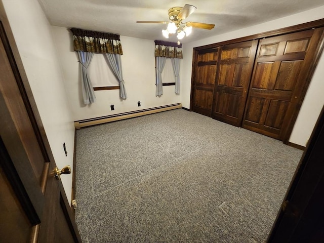 unfurnished bedroom featuring carpet flooring, baseboard heating, and ceiling fan