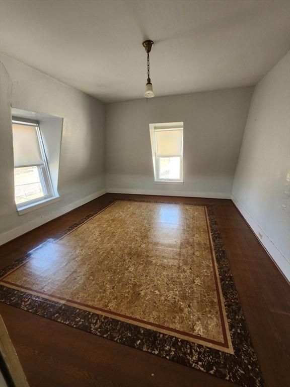 unfurnished room featuring hardwood / wood-style flooring