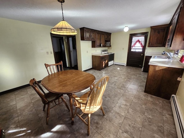 dining room with a baseboard radiator and sink