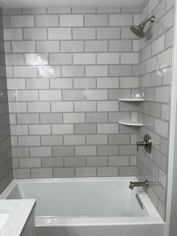 bathroom with vanity and tiled shower / bath combo